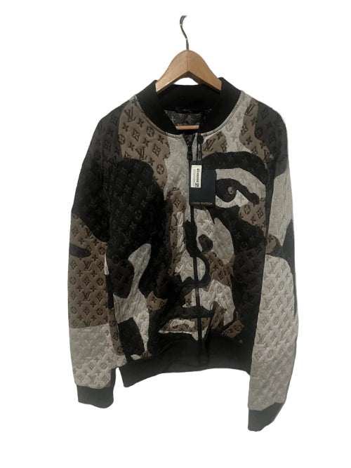 Knitted sweater with face design on a hanger against a white background