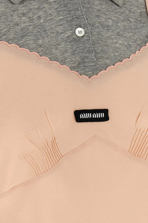 Close-up of a beige garment with a black label featuring the brand 'Miu Miu'.