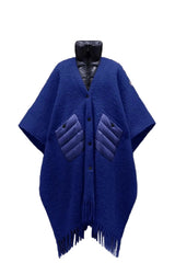 Blue poncho with quilted design on a black background