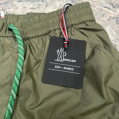 Green pants with a brand label on a plain background
