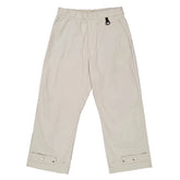 Beige pants with button details on a white background