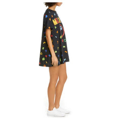 Person wearing a black floral dress with white sneakers on a white background