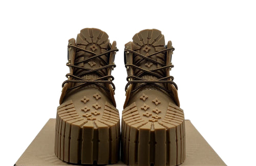 Pair of brown boots with thick soles on a white background