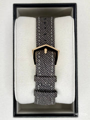 Watch with a textured strap in a box on a white background