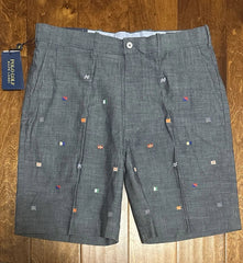 Gray shorts with small decorative elements on a wooden surface