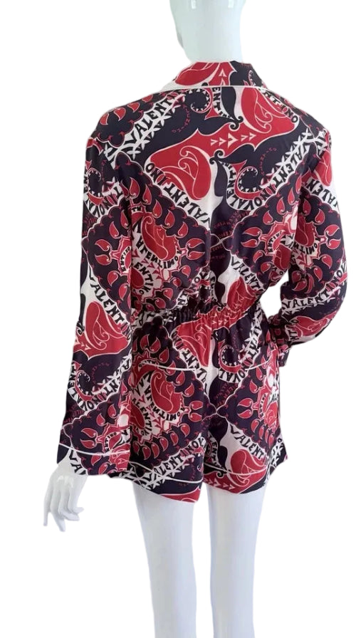 Mannequin wearing a patterned shirt with red, black, and white design on a white background