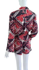 Mannequin wearing a patterned shirt with red, black, and white design on a white background