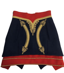 A navy blue skirt with red trim and ornate gold embroidery, laid flat on a light marble surface.