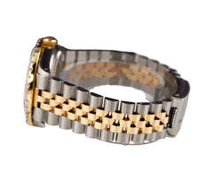 Metallic bracelet with a clasp on a reflective surface
