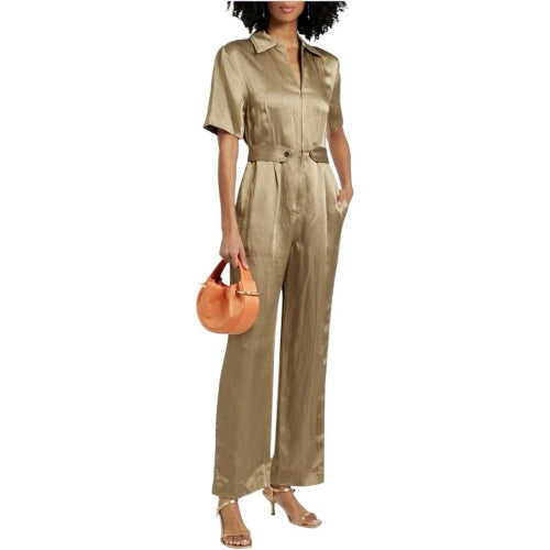 Woman wearing a gold jumpsuit holding an orange handbag on a white background