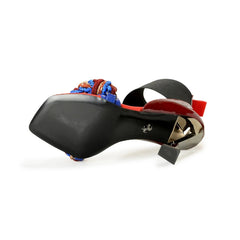 Close-up of a shoe with a colorful bow on a white background