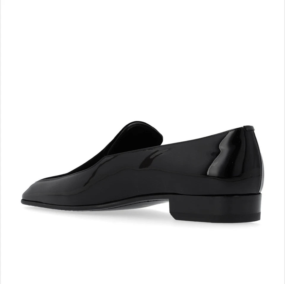 Black loafers on a white background