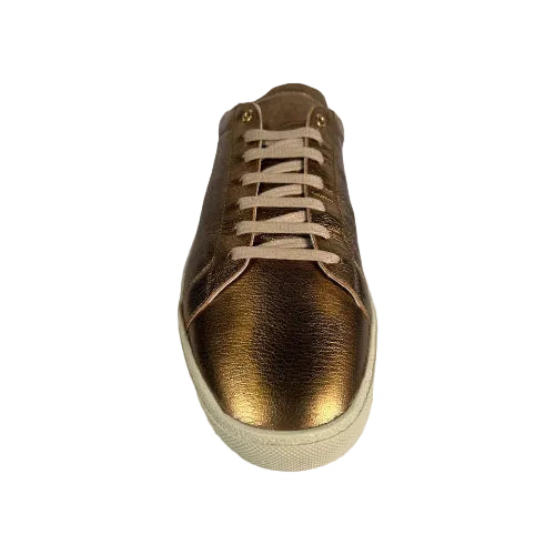 Gold sneaker with beige laces on a white background