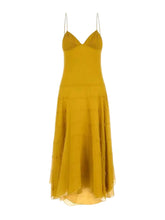 A mustard yellow midi dress with thin spaghetti straps, a sweetheart neckline, and a tiered tulle skirt, shown against a light gray background.
