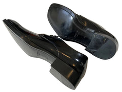 Pair of black dress shoes on a light gray surface