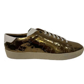 Gold and black sneakers on a white background