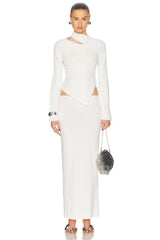 Woman wearing a white dress with a plain background