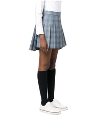 A person wearing a gray and white plaid pleated mini skirt, black knee-high socks, and white sneakers, shown from the waist down against a plain light background.