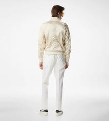 Person wearing a cream-colored jacket and pants on a white background