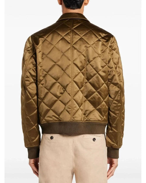 Quilted brown jacket worn by a person on a white background