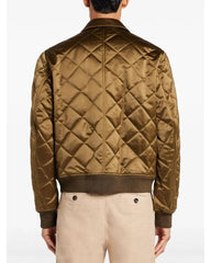 Quilted brown jacket worn by a person on a white background