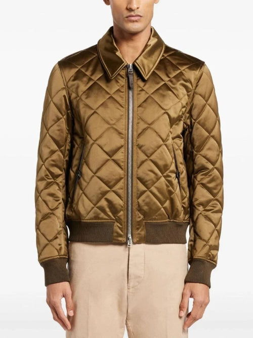 Quilted brown jacket worn by a person on a white background