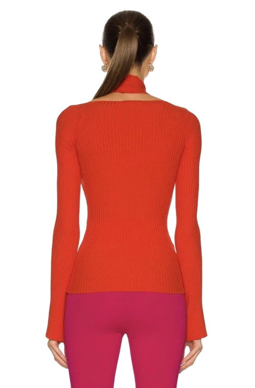 Red ribbed sweater worn by a person on a white background