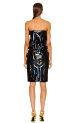 Woman wearing a black strapless dress with reflective material on a white background