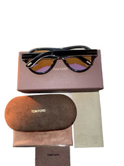 Tom Ford sunglasses with packaging on a wooden surface