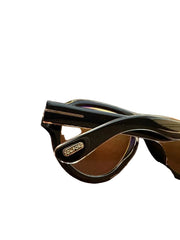 Glasses with a case on a reflective surface
