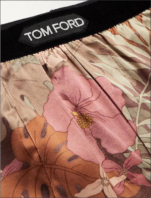 Close-up of Tom Ford men's boxer briefs featuring a pink and orange floral print with a black waistband and a visible TOM FORD label.