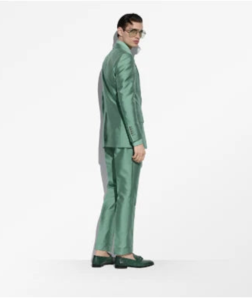 Person wearing a green suit on a white background