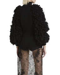 Black textured jacket worn by a person on a white background