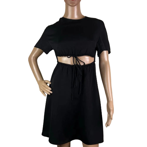 Black dress on a mannequin against a beige background