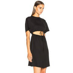 Woman wearing a black dress with cut-out design on a white background