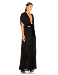 Woman wearing a black evening gown with cut-out design on a white background