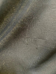 Close-up of textured gray fabric with visible stitching