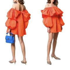Orange off-shoulder dress with ruffled layers worn by a model on a white background