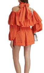 Orange off-shoulder dress with ruffled layers on a white background