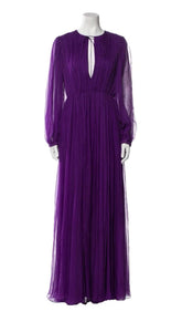 Purple evening gown on a mannequin against a white background