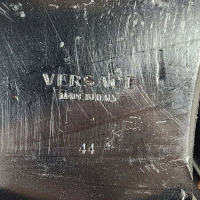 Close-up of a textured surface with 'Versace' branding.