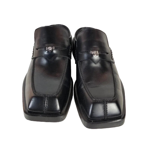 Pair of black leather shoes on a white background