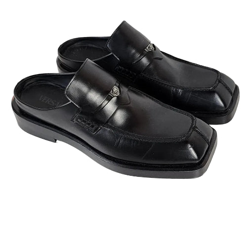 Black sandals with a buckle on a white background