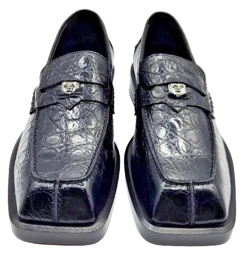 Pair of navy blue crocodile skin loafers on a white background