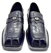 Pair of navy blue crocodile skin loafers on a white background