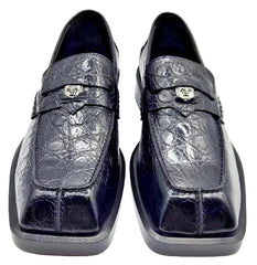 Pair of navy blue crocodile skin loafers on a white background
