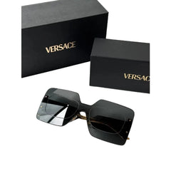 Black Versace sunglasses with a glossy finish, displayed next to their black branded box on a light gray background.