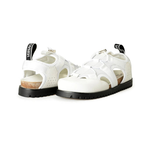 White sandals with black soles on a white background