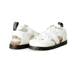 White sandals with black soles on a white background