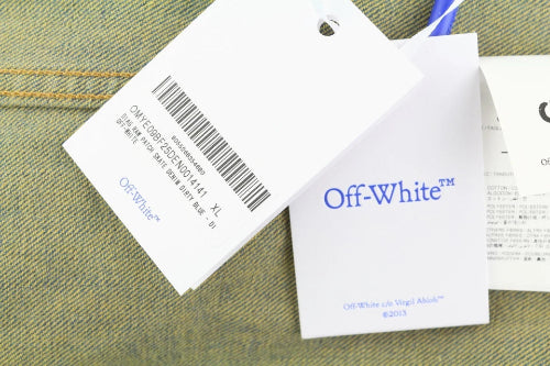 Off-White clothing tags on a textured fabric background